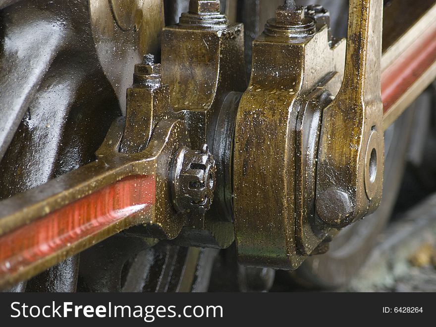 Detail of running gear of old steam engine stained by oil used for lubrication. Detail of running gear of old steam engine stained by oil used for lubrication.