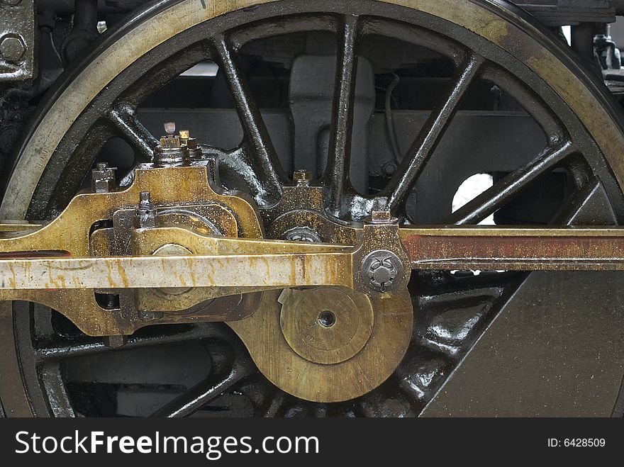 Wheel of old steam engine stained by oil used for lubrication. Wheel of old steam engine stained by oil used for lubrication.