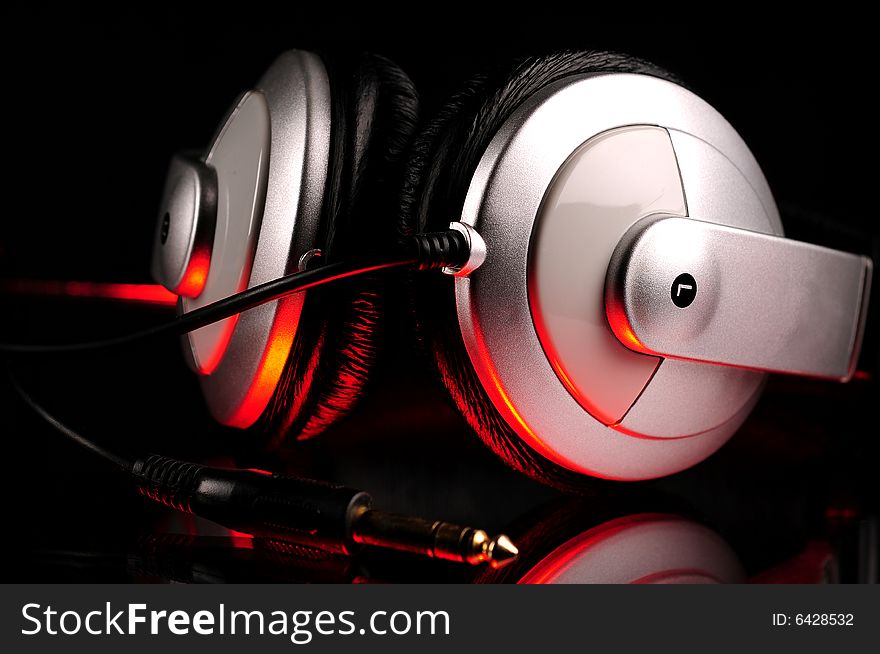 A headphones set over black background