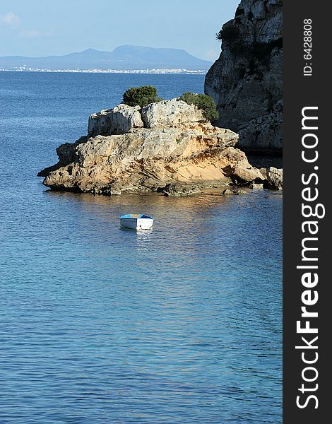 Rock with a boat in a sea in Majorca in Spain