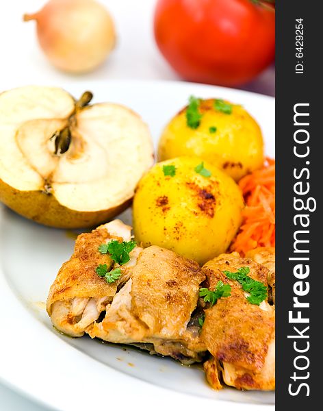 Roasted chicken with apple and fried potatoes.