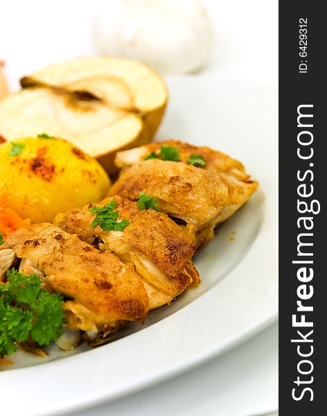 Roasted chicken with apple and fried potatoes.