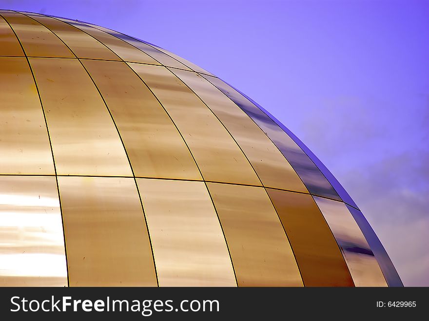 Shiny futuristic metallic dome reflecting the early evening spring sunlight. Shiny futuristic metallic dome reflecting the early evening spring sunlight