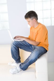 Young Boy Typing On Laptop Stock Images