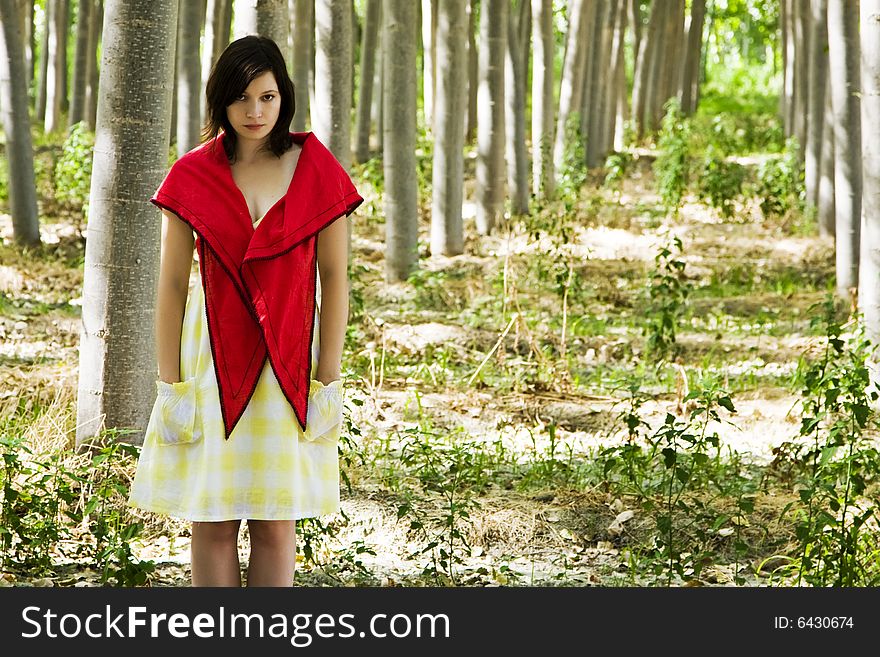 Beautiful woman staring at camera in a forest. Beautiful woman staring at camera in a forest.