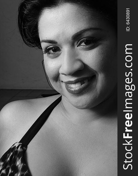 Young hispanic female smiling. Image taken in black and white. Young hispanic female smiling. Image taken in black and white.