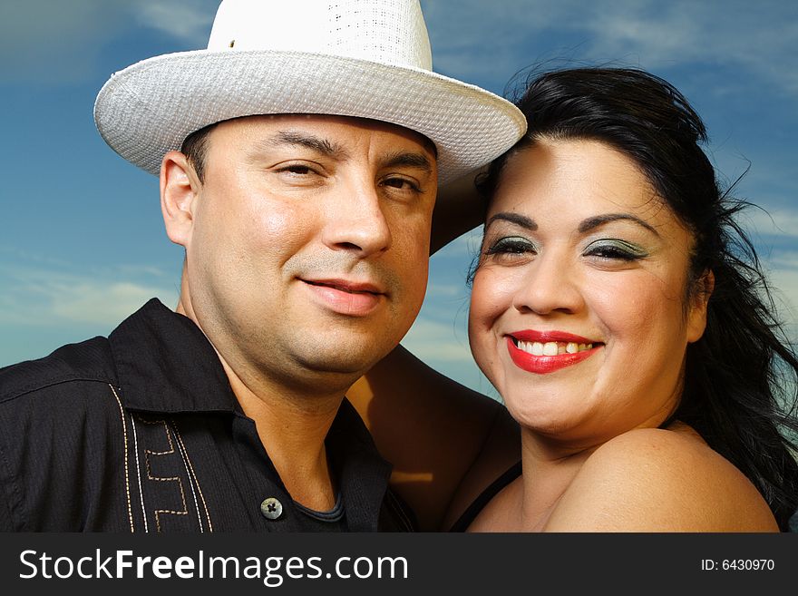 Young happy couple with a beautiful blue sky background. Young happy couple with a beautiful blue sky background.