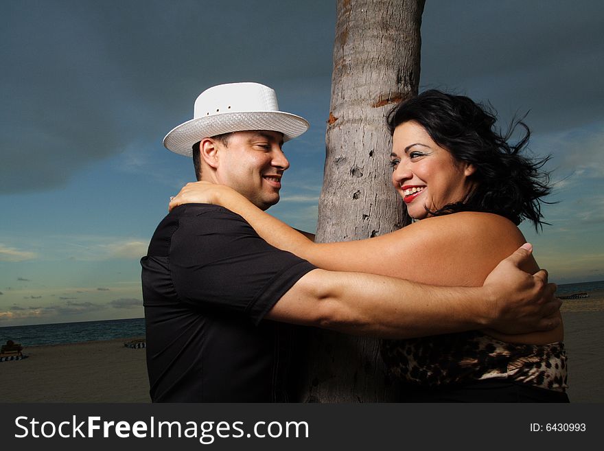 Man and woman hugging with a tree in between them. Man and woman hugging with a tree in between them.