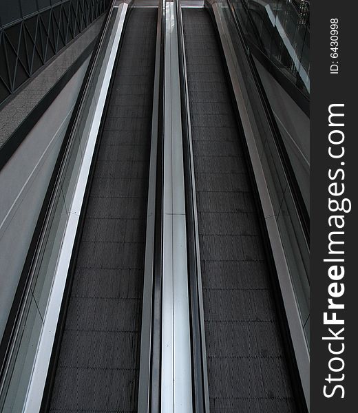 A black escalator in a modern building
