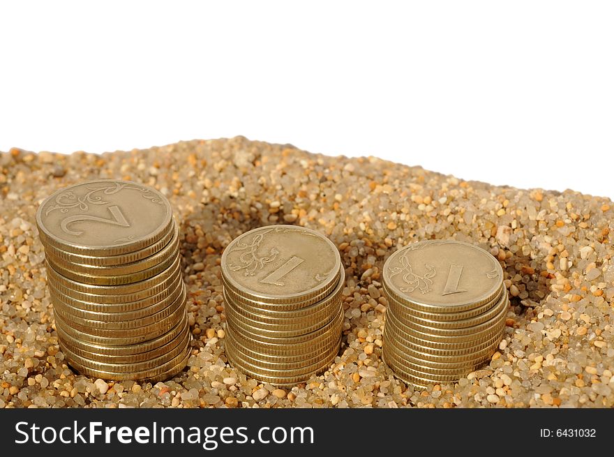 Time is money concept with money coins pyramids in the sand isolated on white