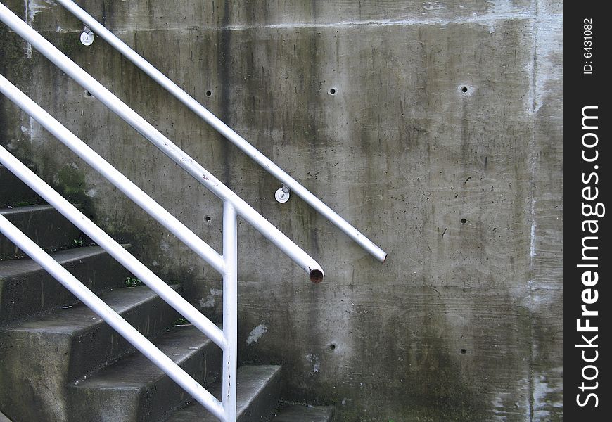 Concrete steps and white railing