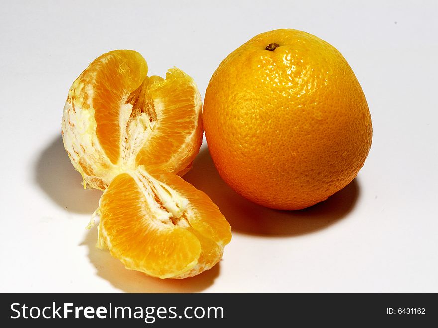 Fresh orange in a bowl on white background