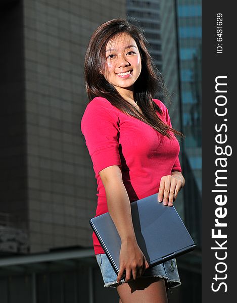 Picture of an Asian Girl with office landscape behind. Suitable for contexts of office environment, casual staff, part-timers, and even interns. Picture of an Asian Girl with office landscape behind. Suitable for contexts of office environment, casual staff, part-timers, and even interns.