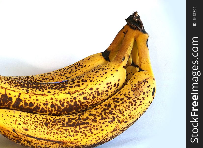 Browning over ripe bananas against white background