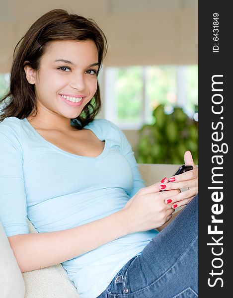 A lifestyle shot of an attractive young woman on the phone. A lifestyle shot of an attractive young woman on the phone