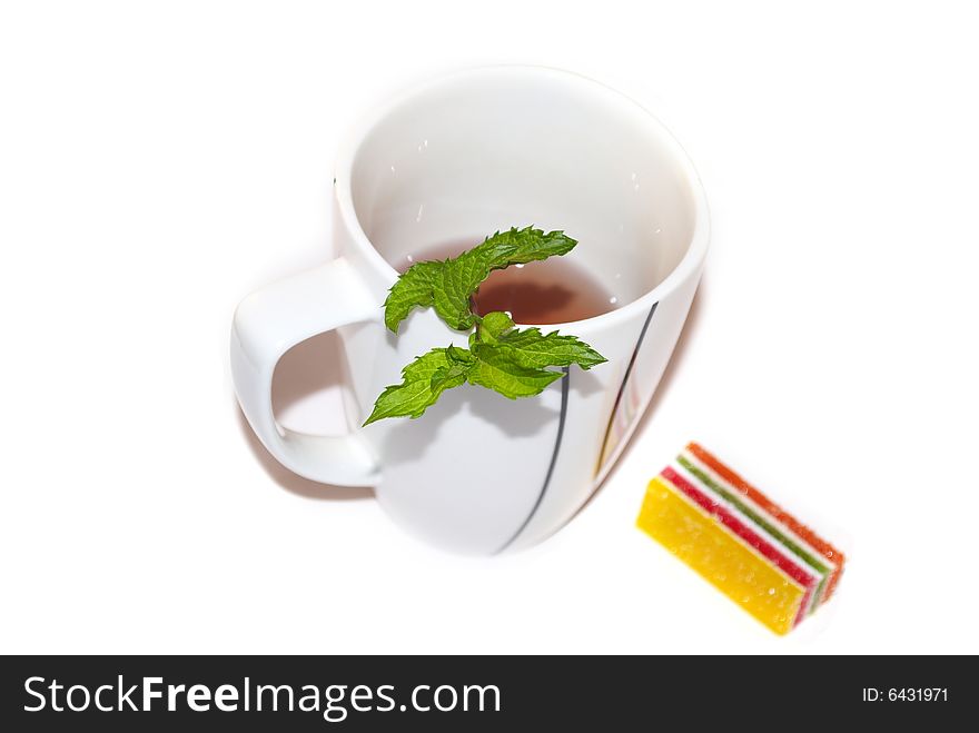 The white tea cup with fresh green mint for breakfast. The white tea cup with fresh green mint for breakfast.