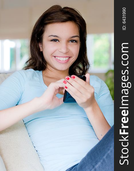 A lifestyle shot of an attractive young woman on the phone. A lifestyle shot of an attractive young woman on the phone