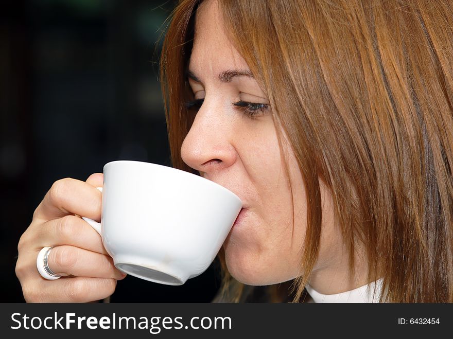 Attractive female enjoying a cup of coffee