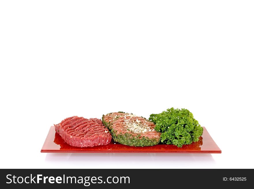 Hamburgers with and without onion on red plate, white background, studio shot, copy space. Hamburgers with and without onion on red plate, white background, studio shot, copy space