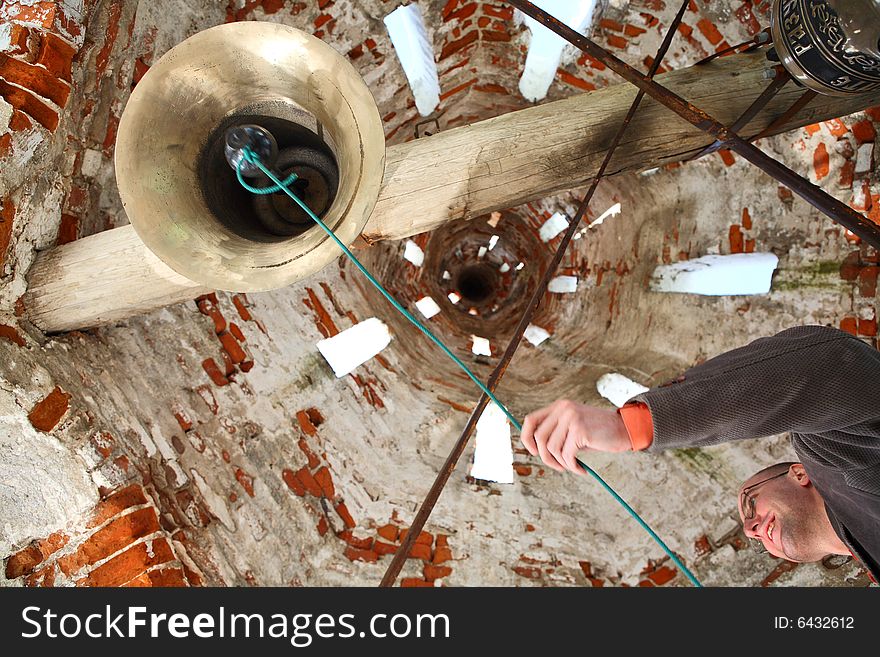 Bell-ringer at belfry of the old Russian Orthodox Church