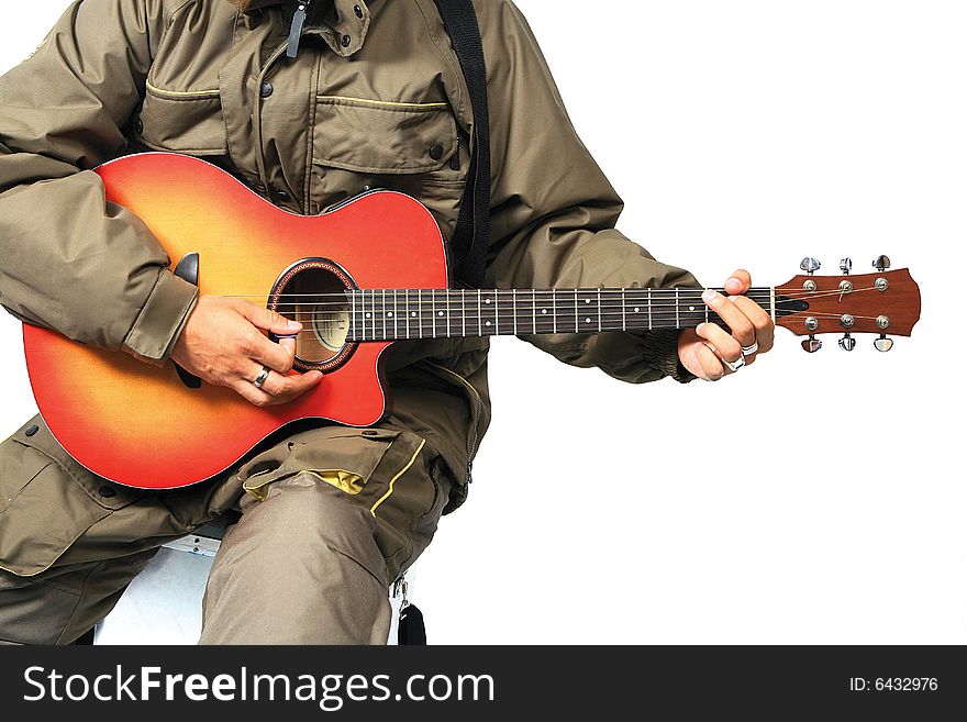 Guitar player in winter jacket sitting on fishing box. Guitar player in winter jacket sitting on fishing box