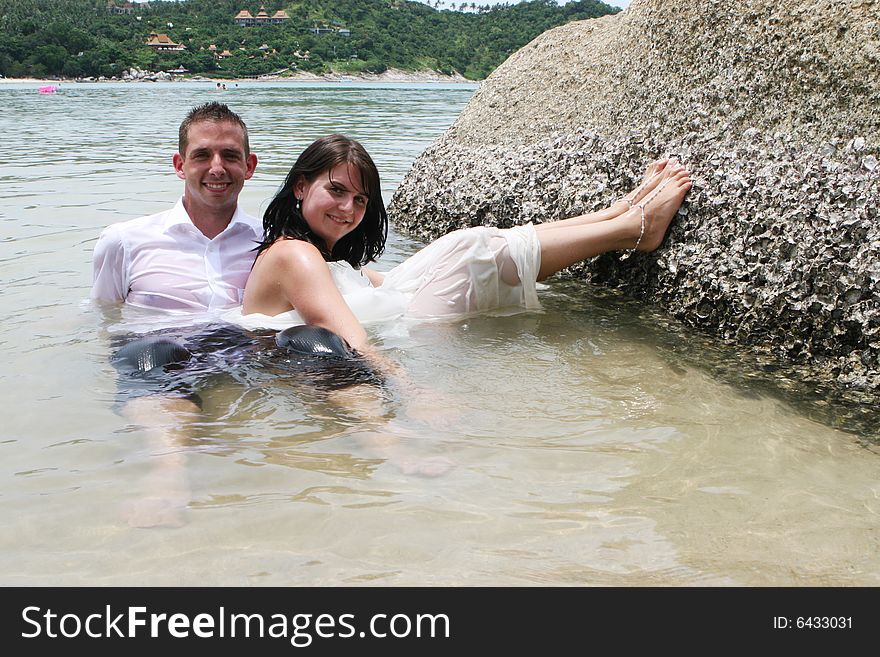 Happy bride and groom during a trash the dress photo shoot.