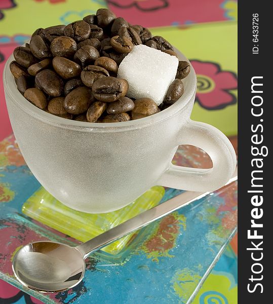 Coffee-beans in a small cup with colourful background. Coffee-beans in a small cup with colourful background