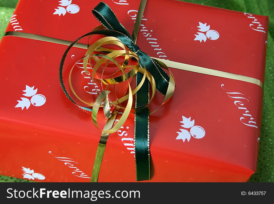 Wrapped christmas gift on a green background. Wrapped christmas gift on a green background