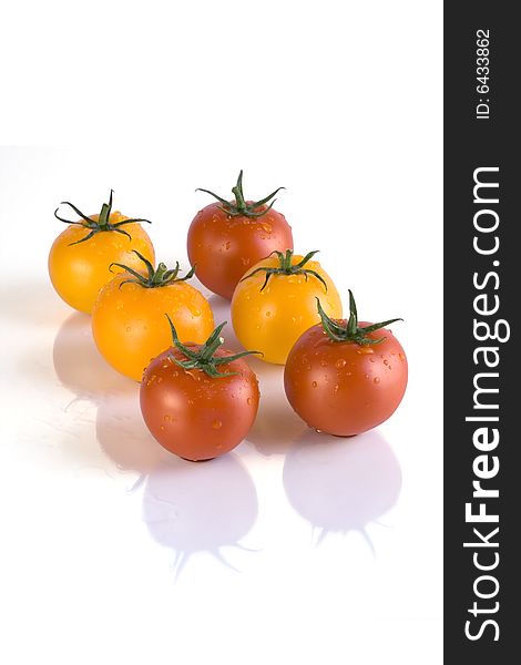 Red and yellow tomatoes with white background. Red and yellow tomatoes with white background