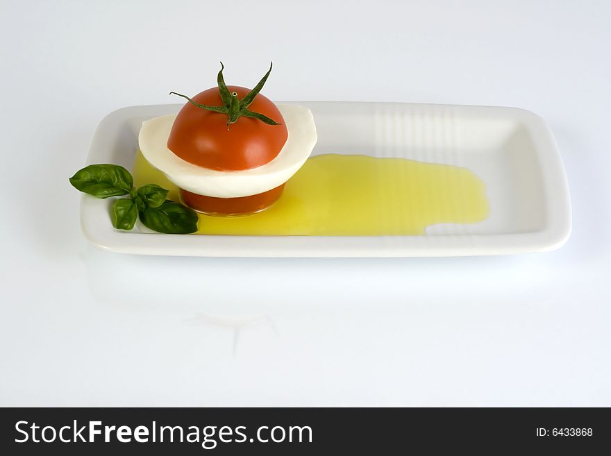 Tomato with mozzarella, basil and olive oil. Tomato with mozzarella, basil and olive oil