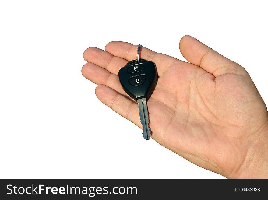 The black car key with buttons lies on a man's hand. White background. The black car key with buttons lies on a man's hand. White background