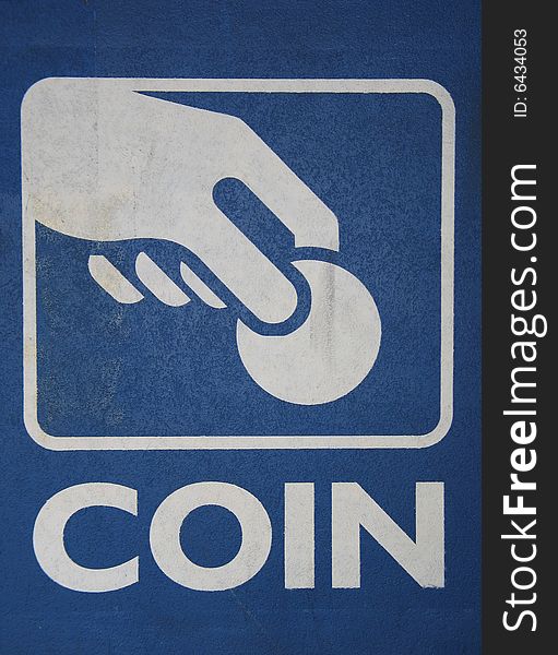 A vertical blue and white coin sign. A vertical blue and white coin sign