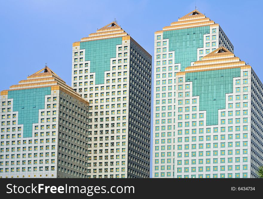 Four modern office buildings against blue sky