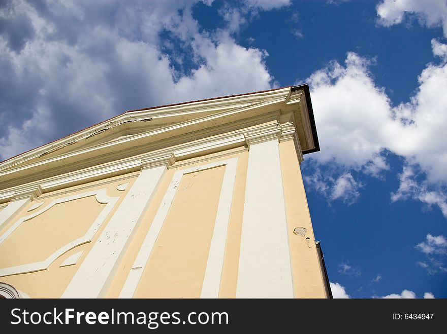 Old church on the cloudy sky background