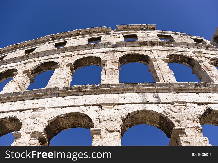 Famous italian amphitheater on the blue sky background. Famous italian amphitheater on the blue sky background