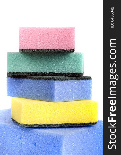 Five colorful bath sponges close-up isolated on white background