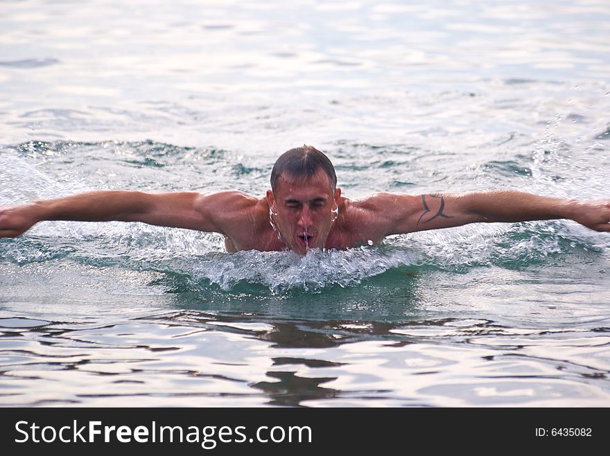 Swaming man in the black sea in Russia