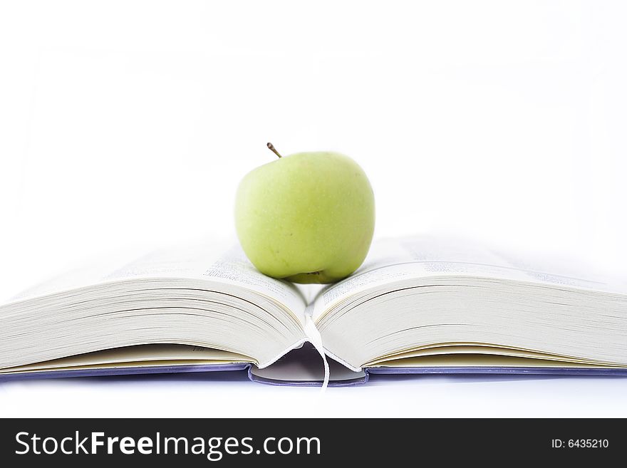 Apple with green book on white background. Apple with green book on white background