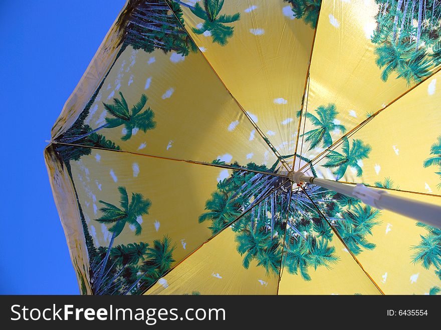 Beach umbrella on blue sky