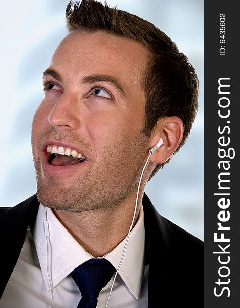 Portrait of businessman listening music on an isolated white background