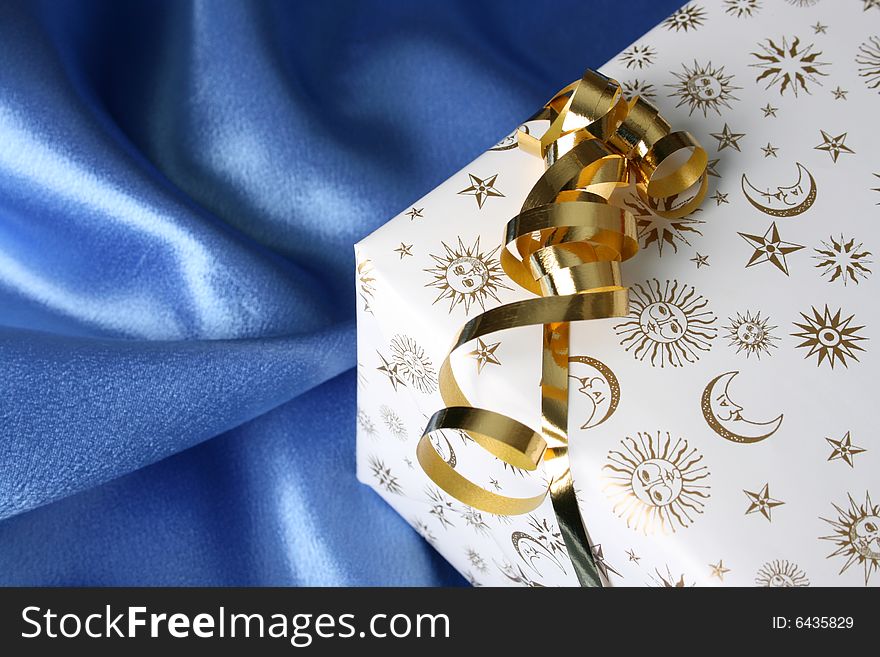 Wrapped Christmas present with a golden ribbon. Wrapped Christmas present with a golden ribbon
