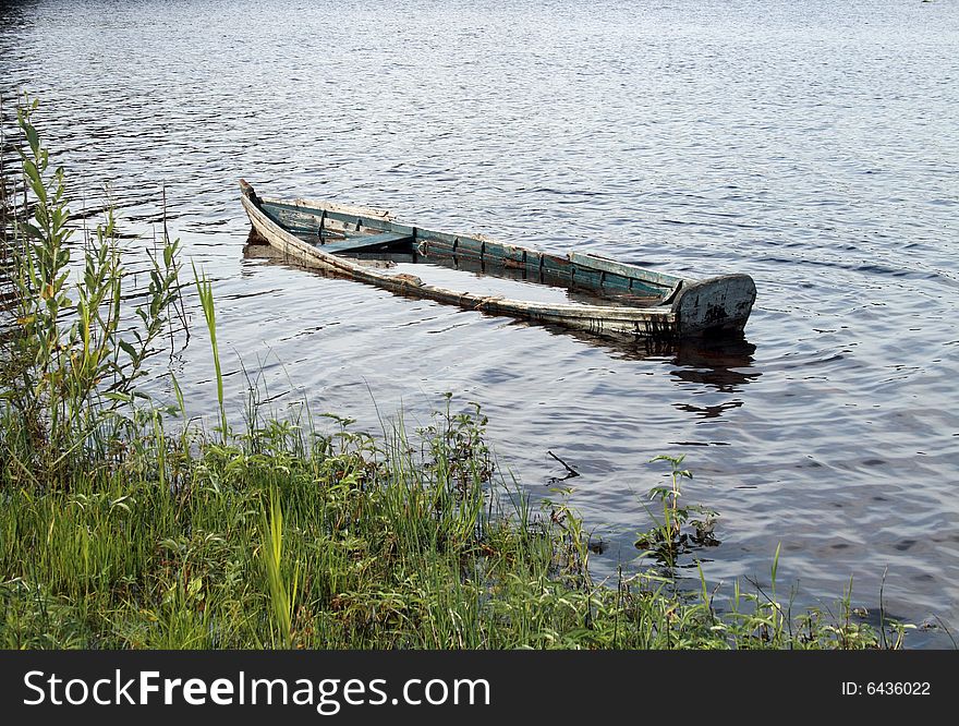 Old wooden boat completed with water in the river. Old wooden boat completed with water in the river