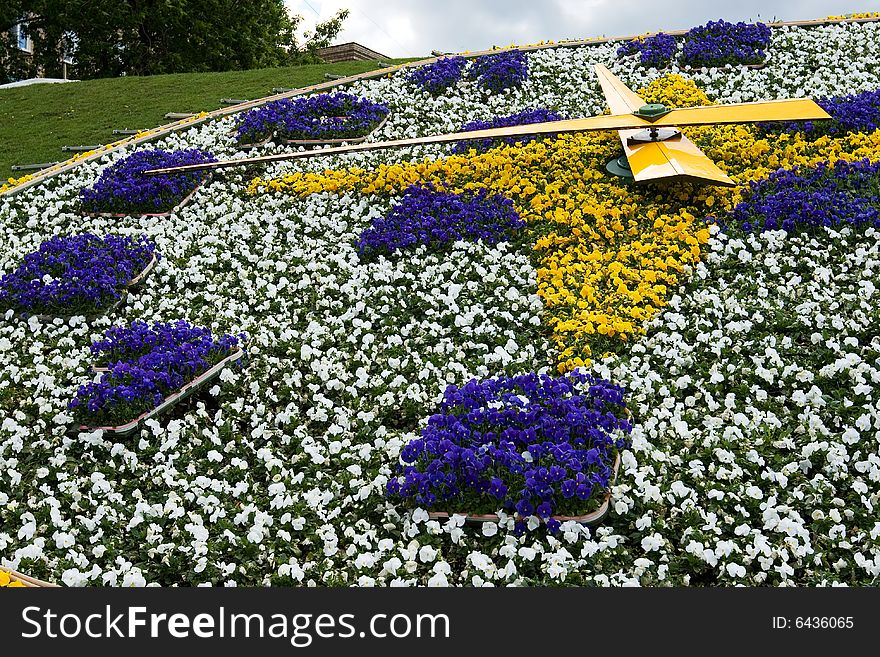 A closeup of a clock made of flowers outdoors. A closeup of a clock made of flowers outdoors