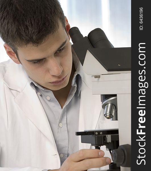 Young Scientist Watching Inside A Microscope