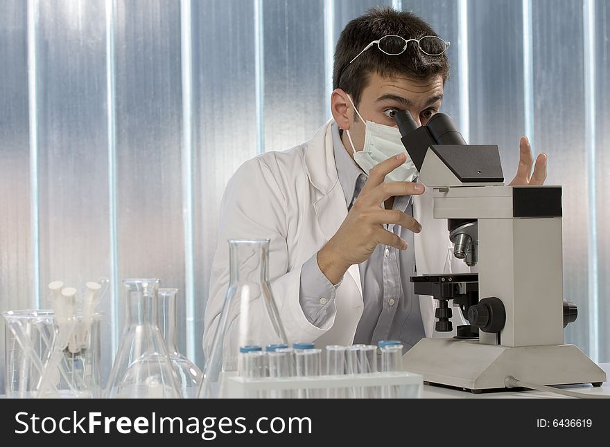 Scientist working at microscope, chemistry related or medical design. Scientist working at microscope, chemistry related or medical design