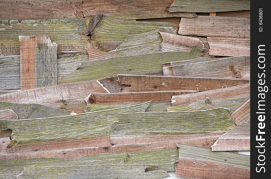 An old shed repaired with pieces of broken wooden planks. An old shed repaired with pieces of broken wooden planks.