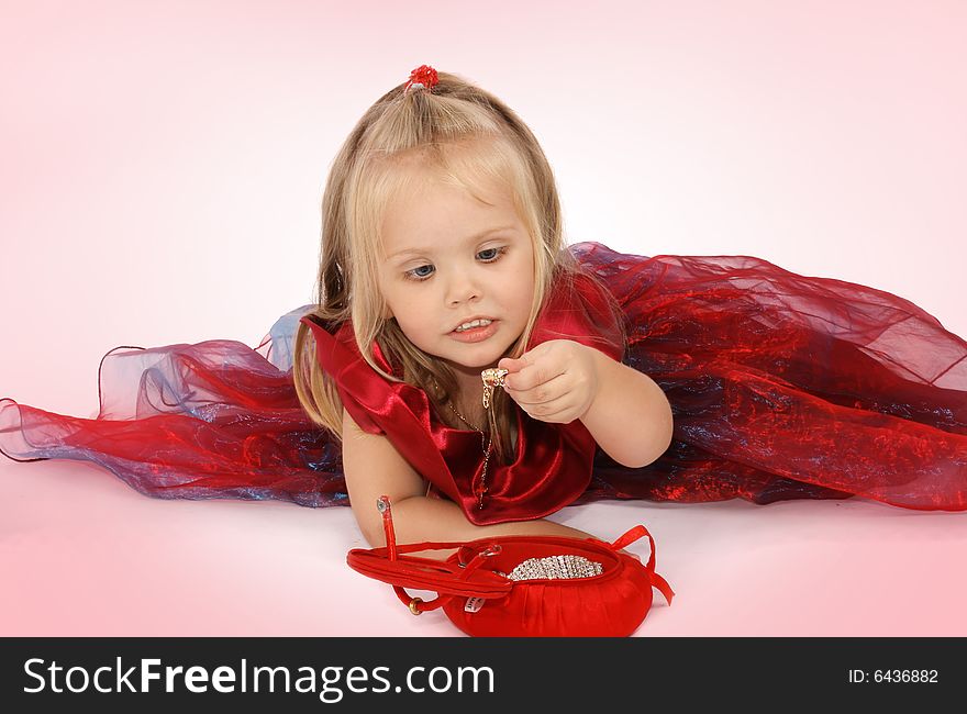 Portrait of the beautiful girl in a red dress