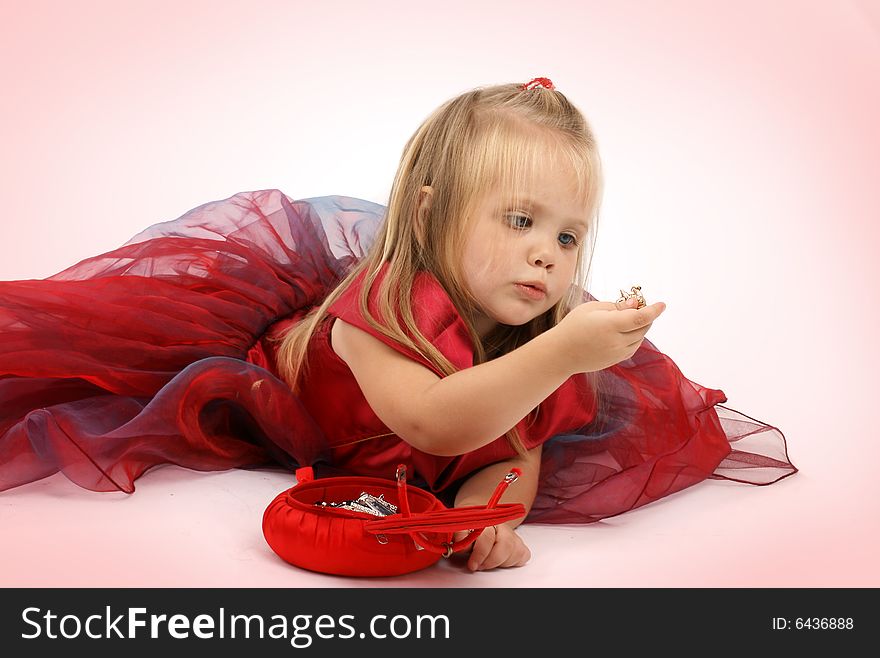 Portrait of the beautiful girl in a red dress