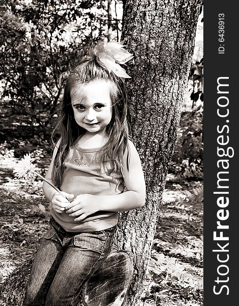 Little girl in an outdoor setting in brown tones. Little girl in an outdoor setting in brown tones