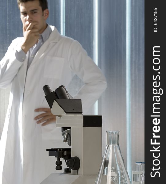 Young scientist thinking in his lab